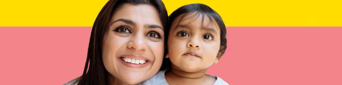 a young women smiles with a young child