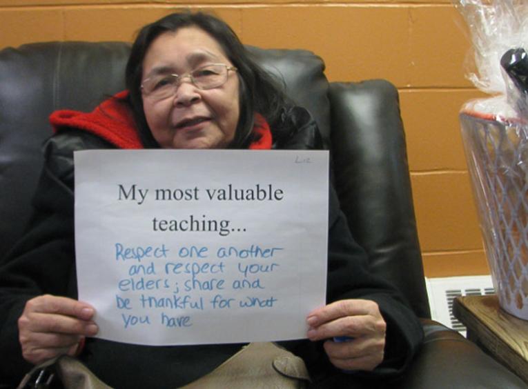 Person holding sign with their most valuable teaching.