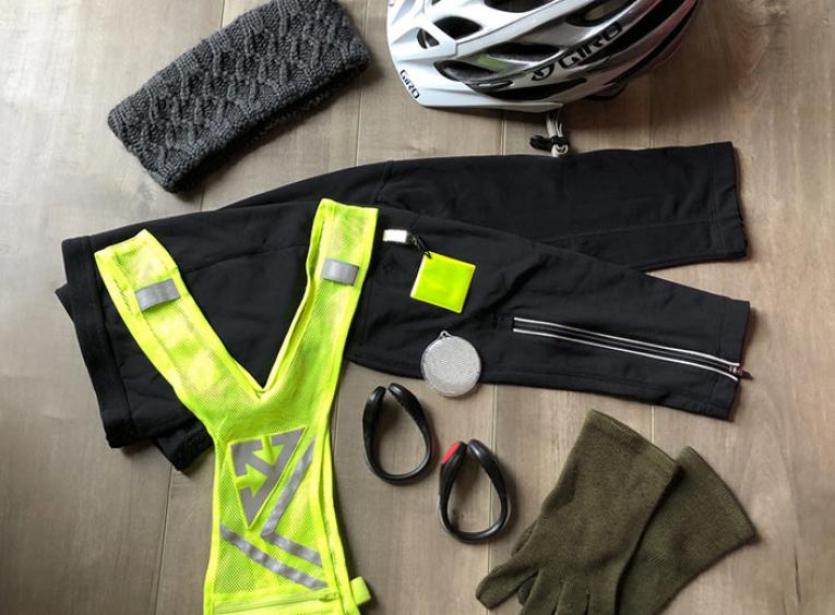 Fall biking gear, like pants, a high-visibility vest, helmet, and gloves.