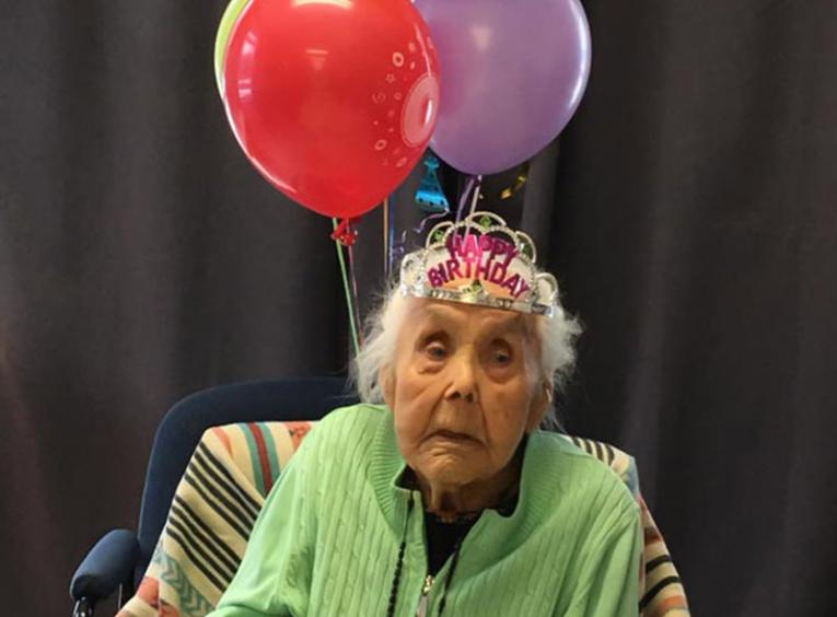 Catherine William celebrating her 103rd birthday with balloons.