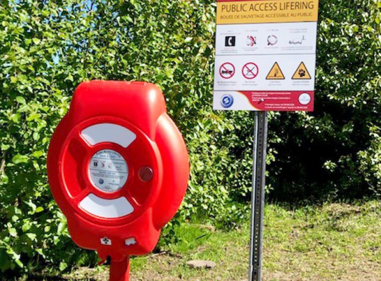 The installed Public Access Lifering is beside a sign that explains how to use it.