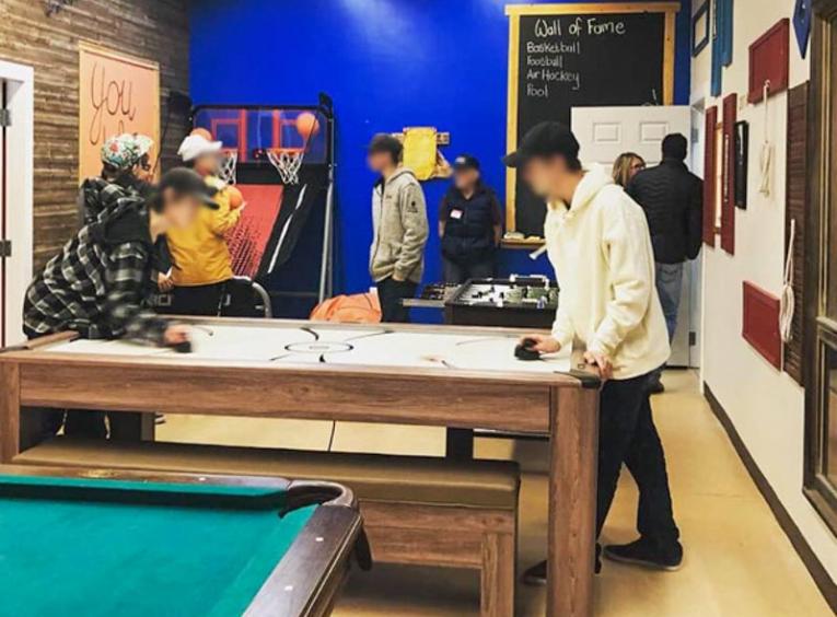 Youths playing air hockey