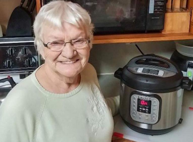 Adele's mom standing with her Instant Pot.