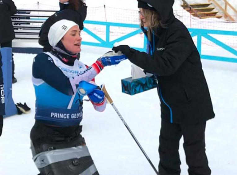 Laura Elsenheimer offering a tissue to para nordic skier Birgit Skarstein.