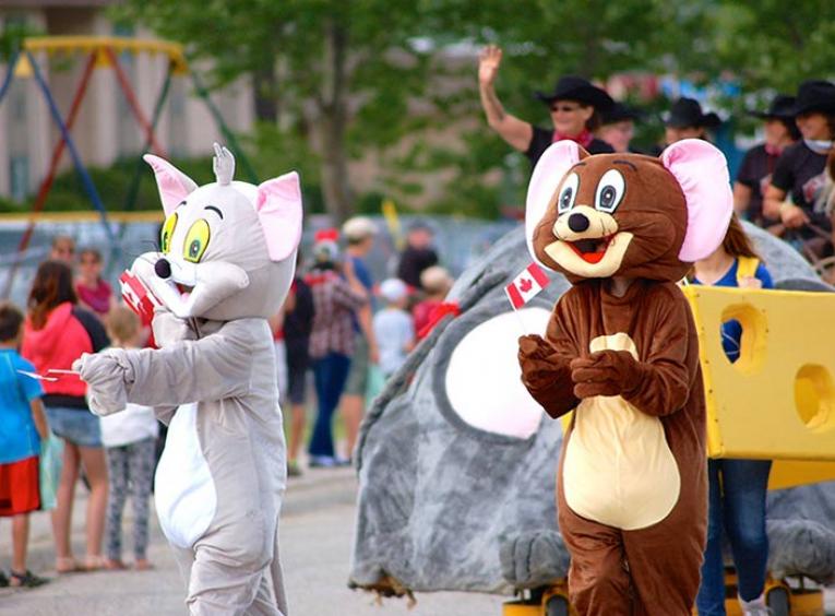 Parade with brown mouse and grey cat mascot