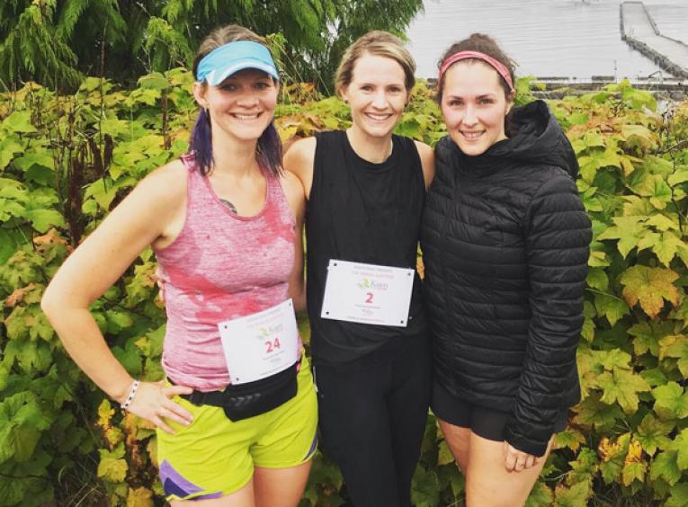 Three Prince Rupert staff who took part in a trail run are pictured wearing running gear.