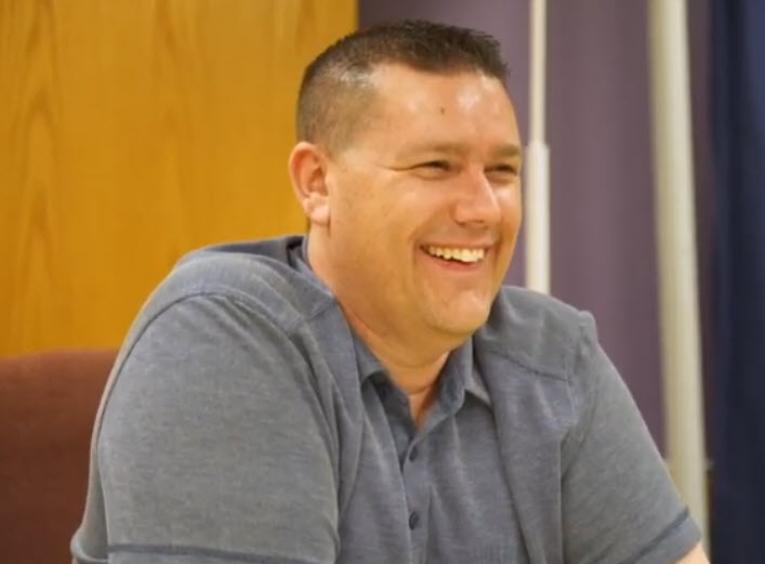 Ryan Challen sitting at a table.