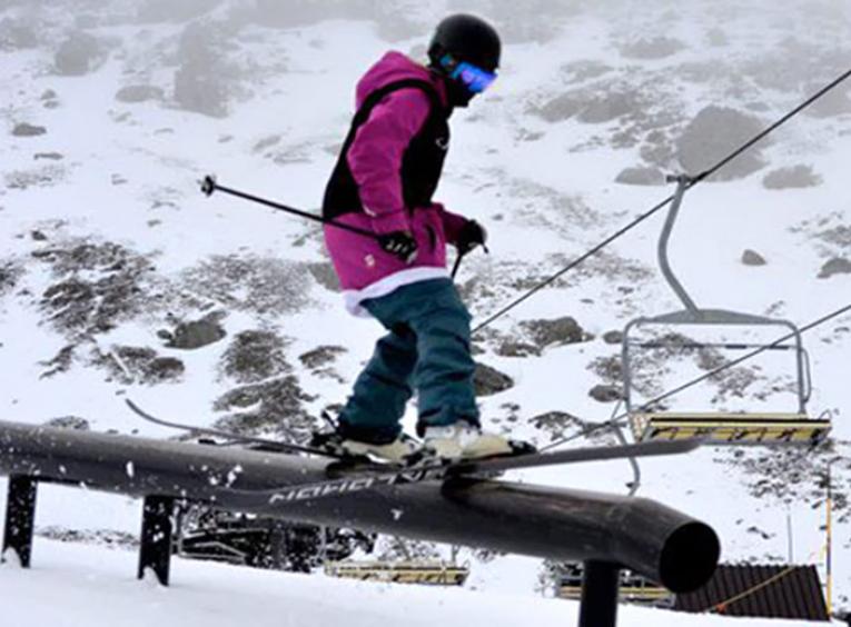 Skier sliding on a rail.