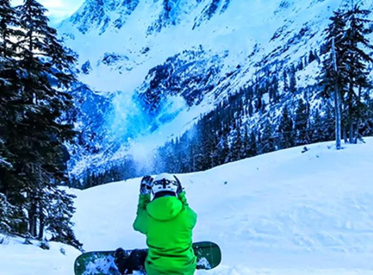 snowboarder sitting down on a ski hill
