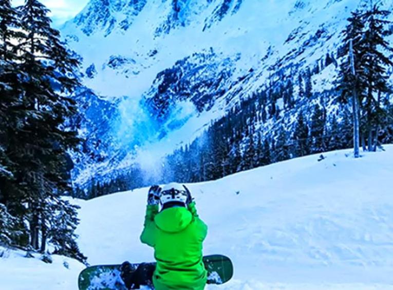 snowboarder sitting down on a ski hill