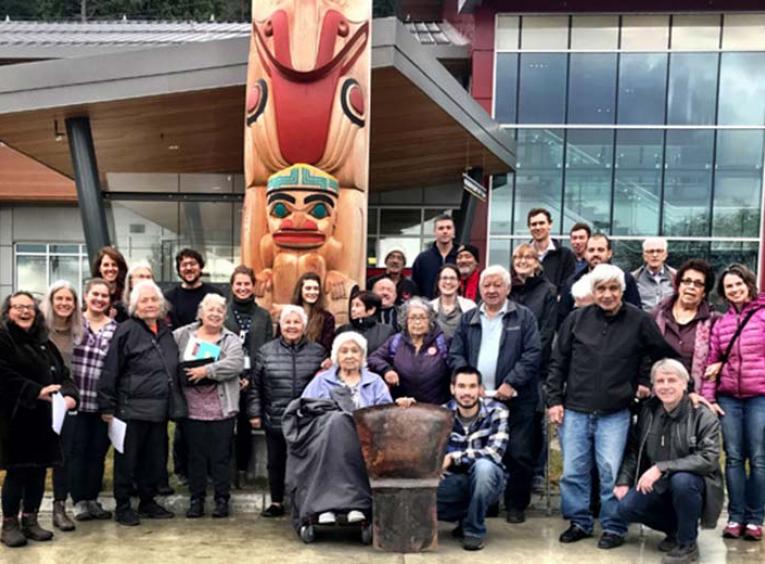 A group of people standing outside the Haida Gwaii Hospital and Health Centre.