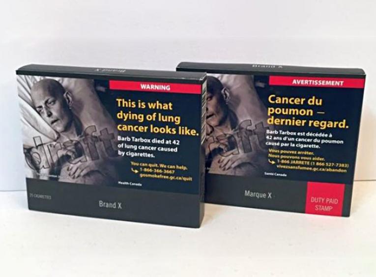 Two cigarette boxes in the new plain packaging.