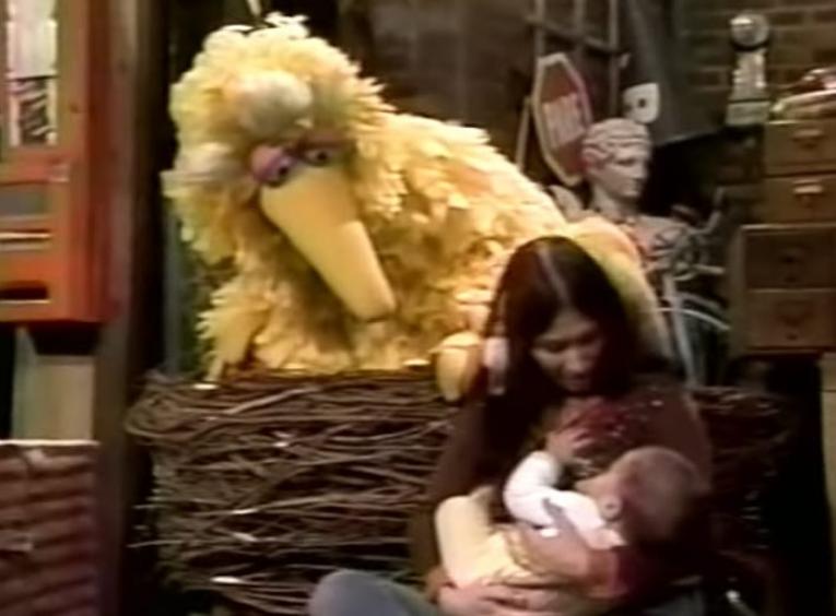 Big watching a woman breastfeeding her baby.