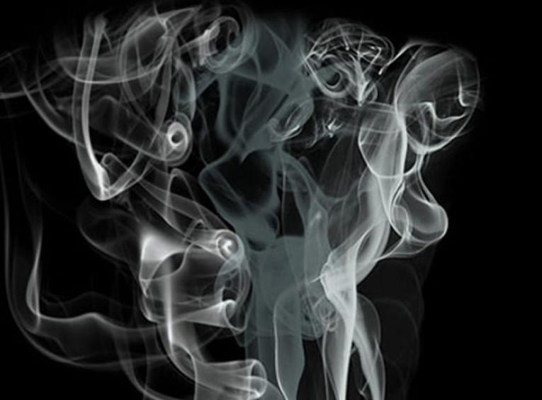 Swirling smoke against a black background.