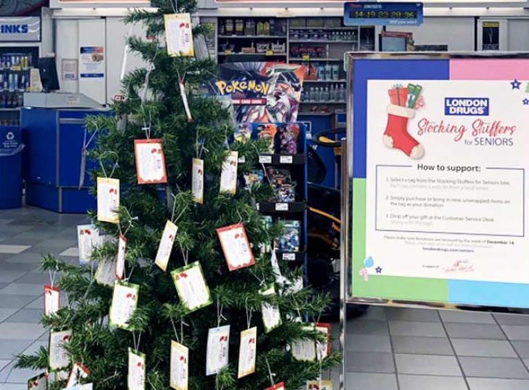 Christmas tree in the Prince George London Drugs store is decorated with tags containing seniors' gift wishes.