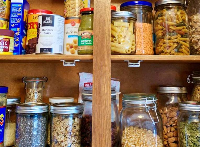 A stocked pantry, full of canned and tried items.