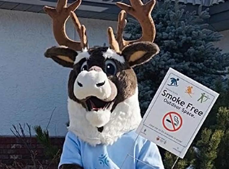 Mascot with smoke-free spaces sign
