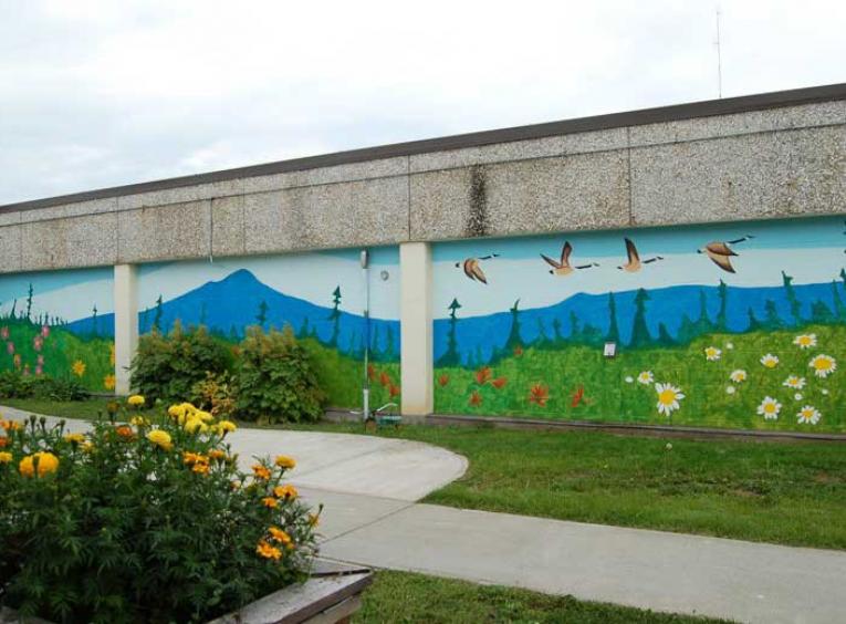 Beautiful mural on outdoor wall of long term care garden