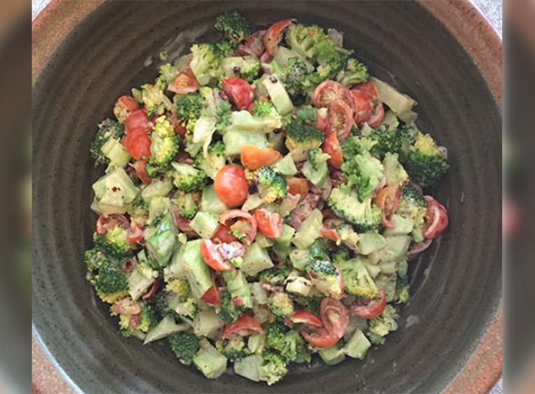 Bowl with broccoli salad and tomatoes