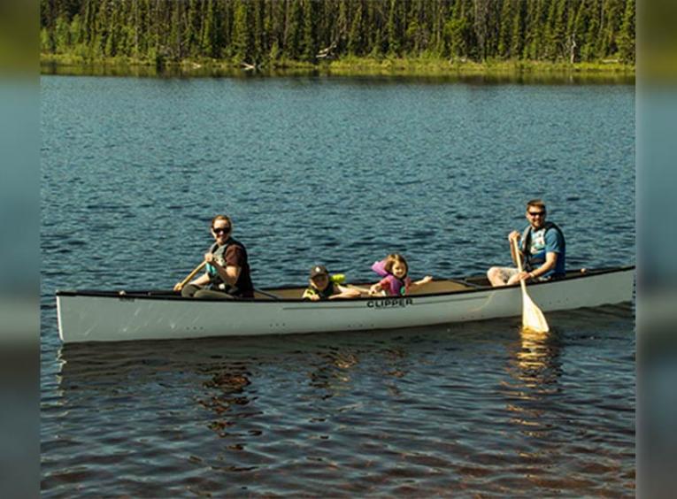 Family in a canoe on a lake.