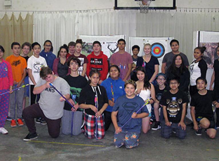 Group of young people with archery equipment