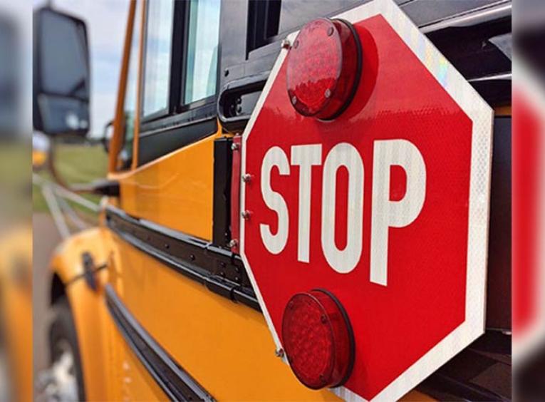 Stop sign on the side of a school bus