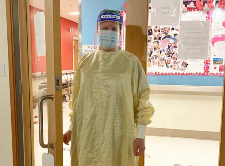Nurse wearing face shield and personal protective equipment