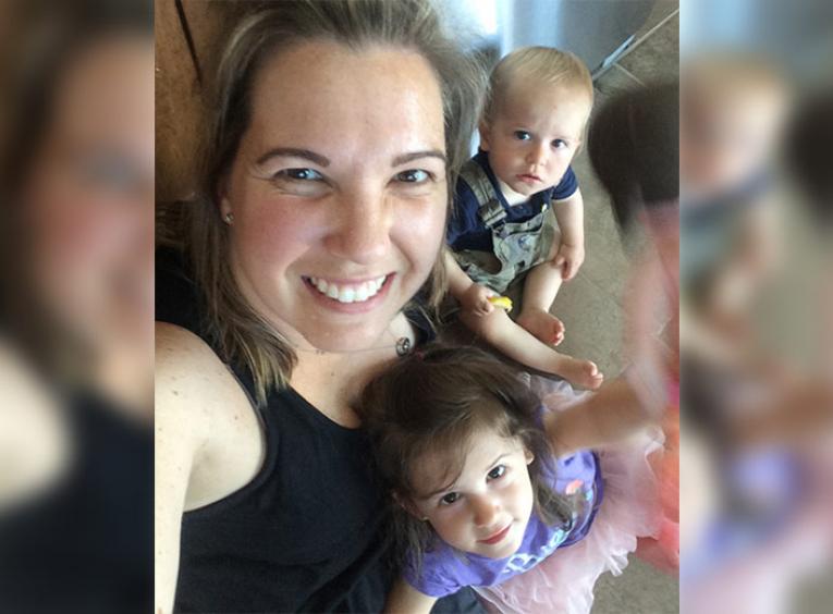Woman smiling with her two children.