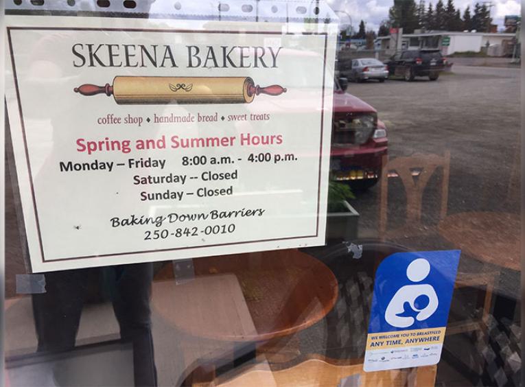 Skeena Bakery sign and breastfeeding decal on a window.