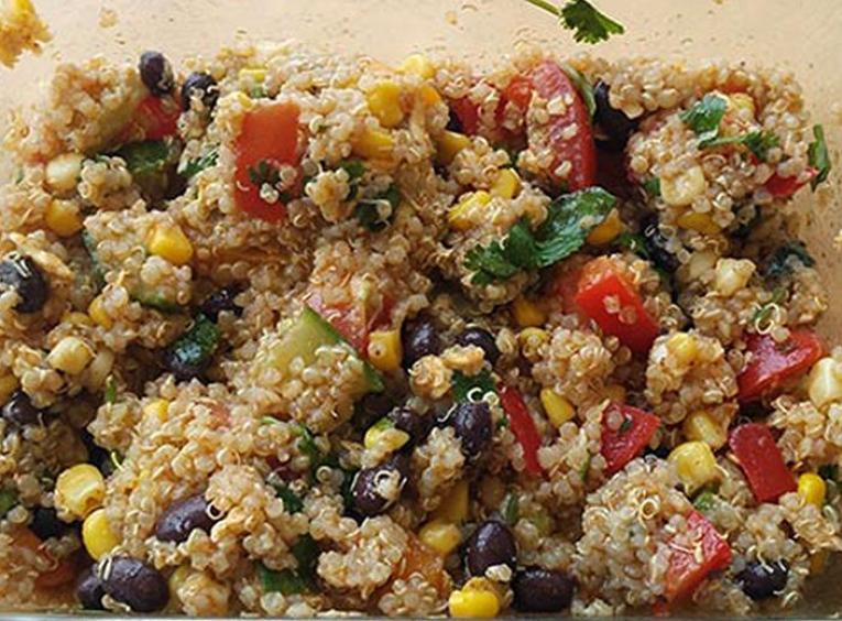 Quinoa salad with vegetables in a glass pan