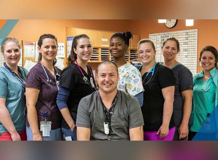 a group shot of health care workers in scrubs