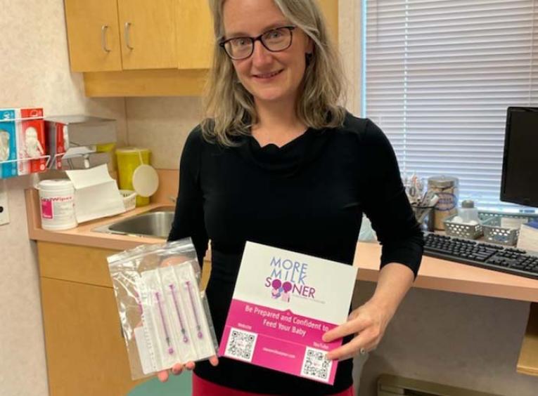 a woman with grey hair holding pamphlet