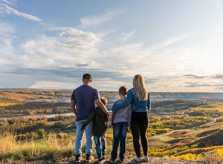 Family stands on edge of valley