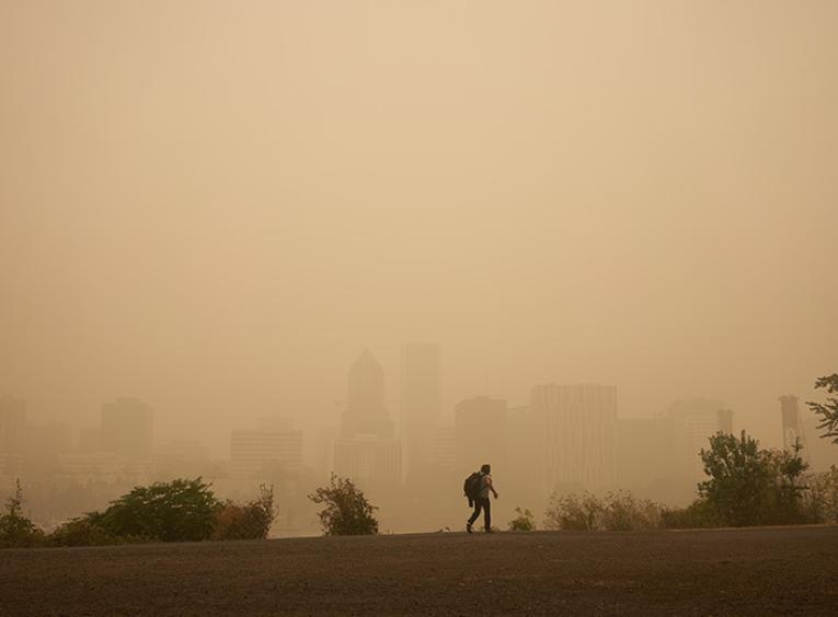 person walking in smoky conditions