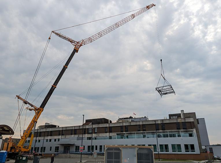 Large construction crane in front of a hospital facility. 