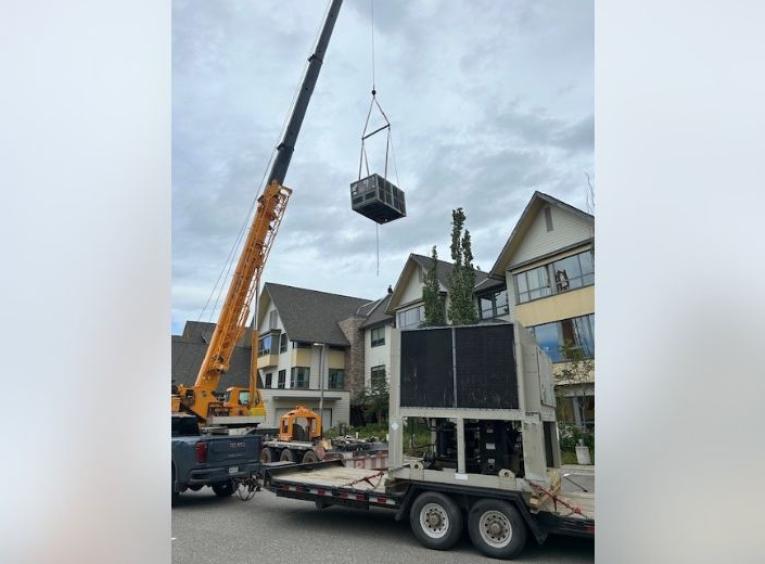 A crane moving the new ciller ventilation system into place. 