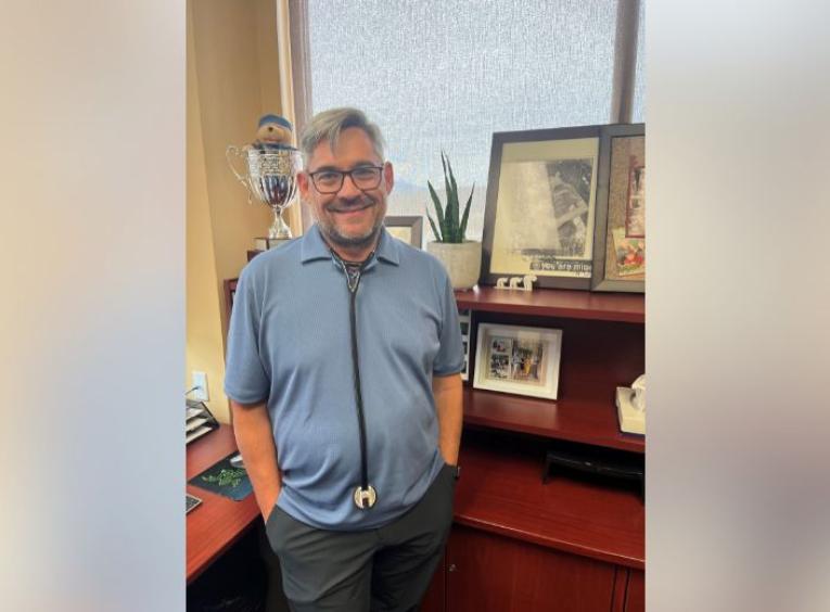 Dr. Strydom standing in his office