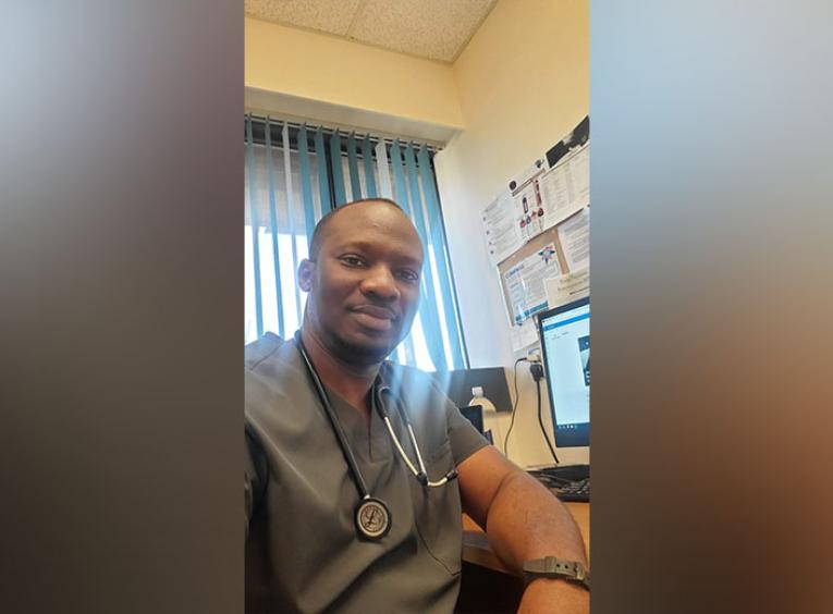 Man in scrubs in a medical office.