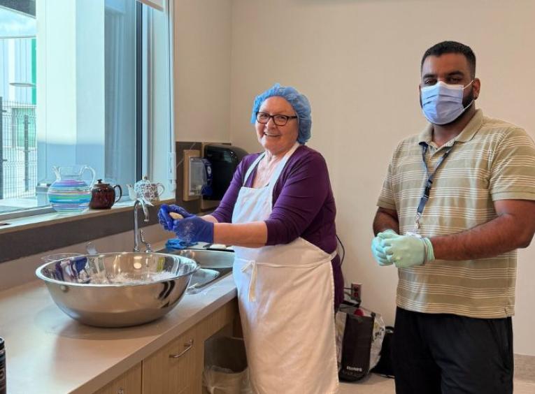 Indigenous Care Team member, Angie Prince, and Activity Worker, Simar Kalra, making Bannock at Nats’oojeh Hospital and Health Centre in Fort St. James.