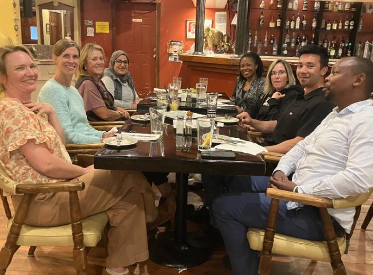 Group of medical providers sit around a table