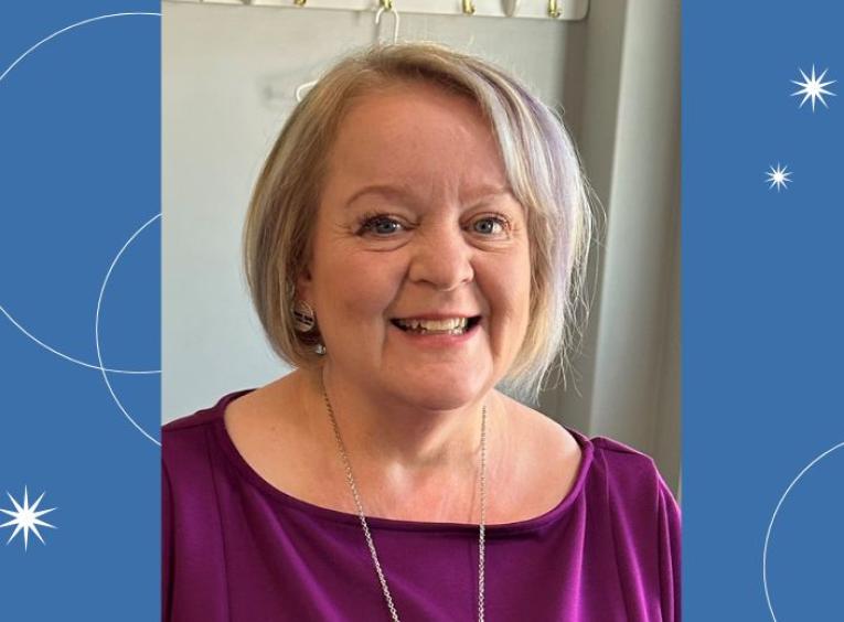 Older woman with short grey blonde hair. 