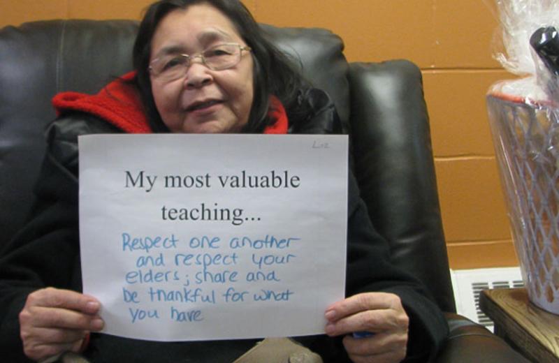 Person holding sign with their most valuable teaching.