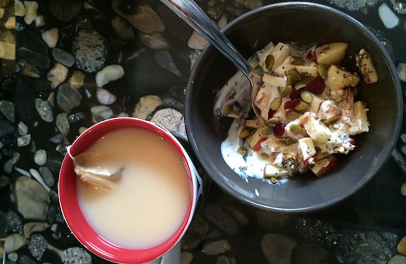 Bowl of yogurt with cup of tea.