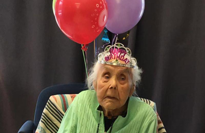 Catherine William celebrating her 103rd birthday with balloons.