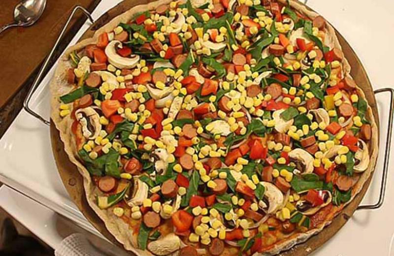 Pizza with corn, mushrooms, peppers, and pepperoni toppings