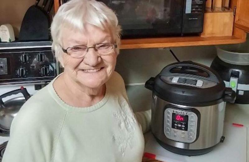 Adele's mom standing with her Instant Pot.