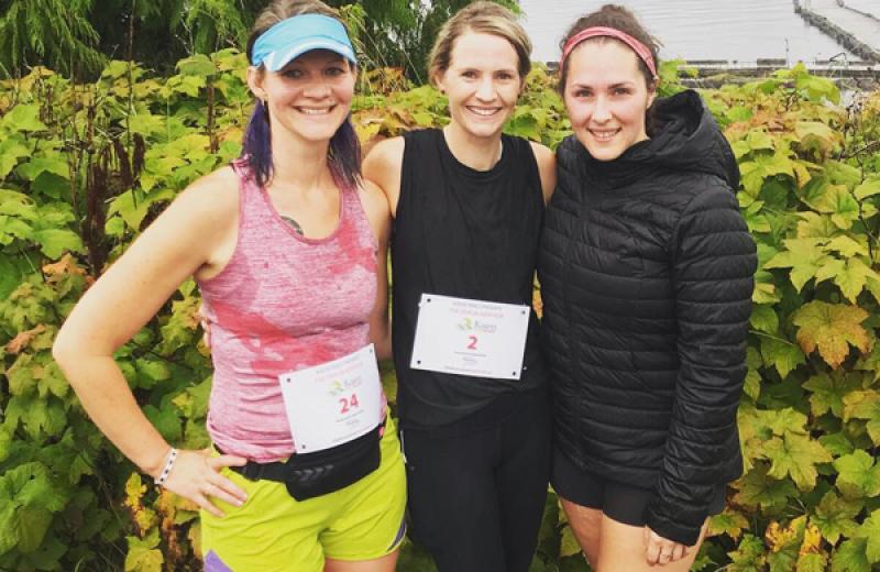 Three Prince Rupert staff who took part in a trail run are pictured wearing running gear.
