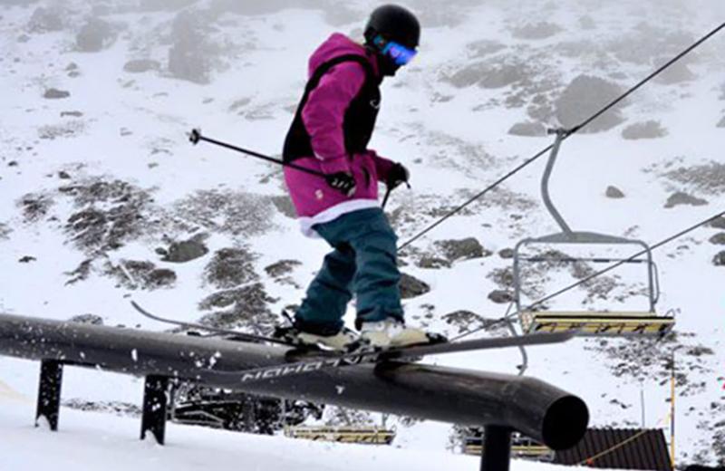 Skier sliding on a rail.