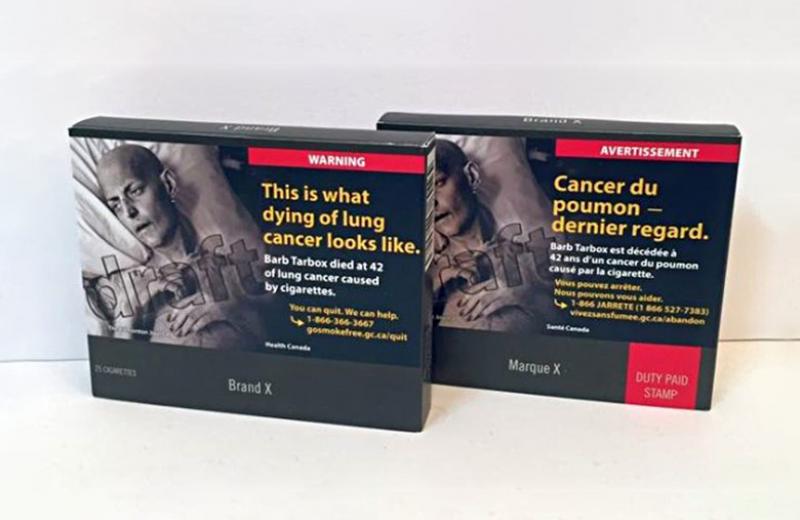 Two cigarette boxes in the new plain packaging.