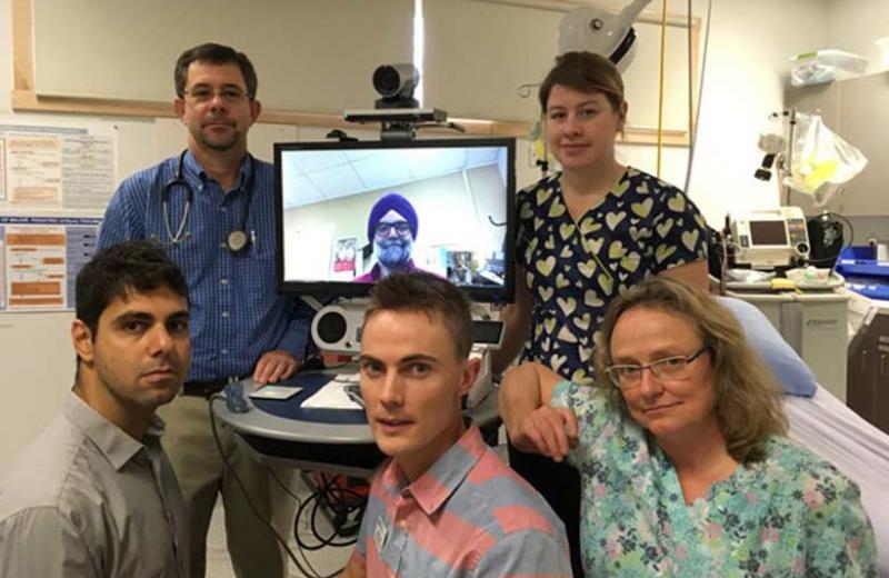 Health care providers posing with a telehealth system.